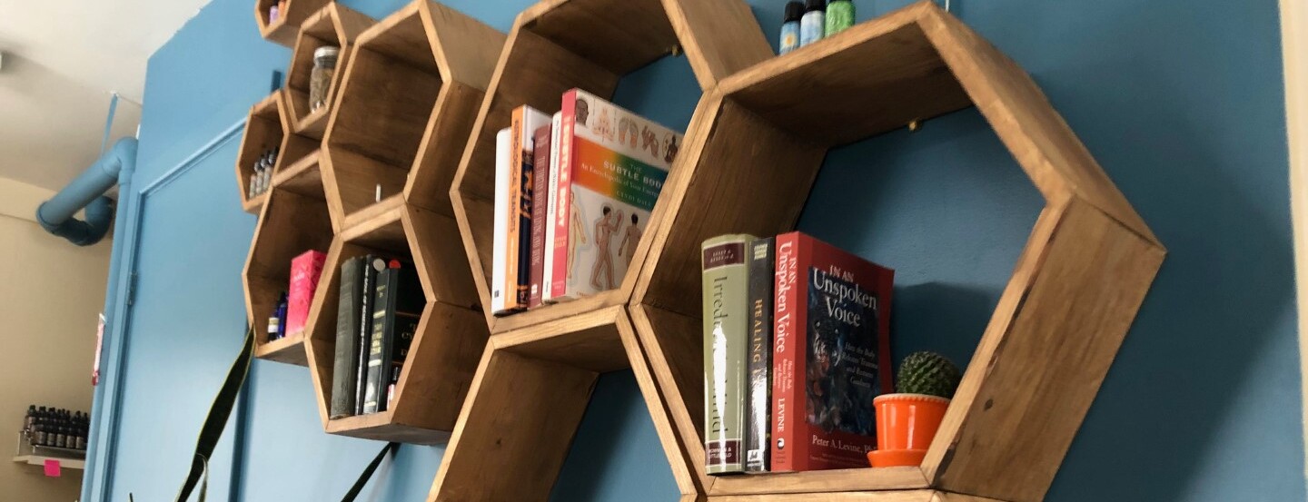 hexagon shelves with books about health on them